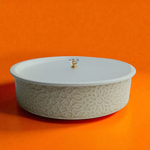 Stack of ceramic plates with decorative edge on a white surface